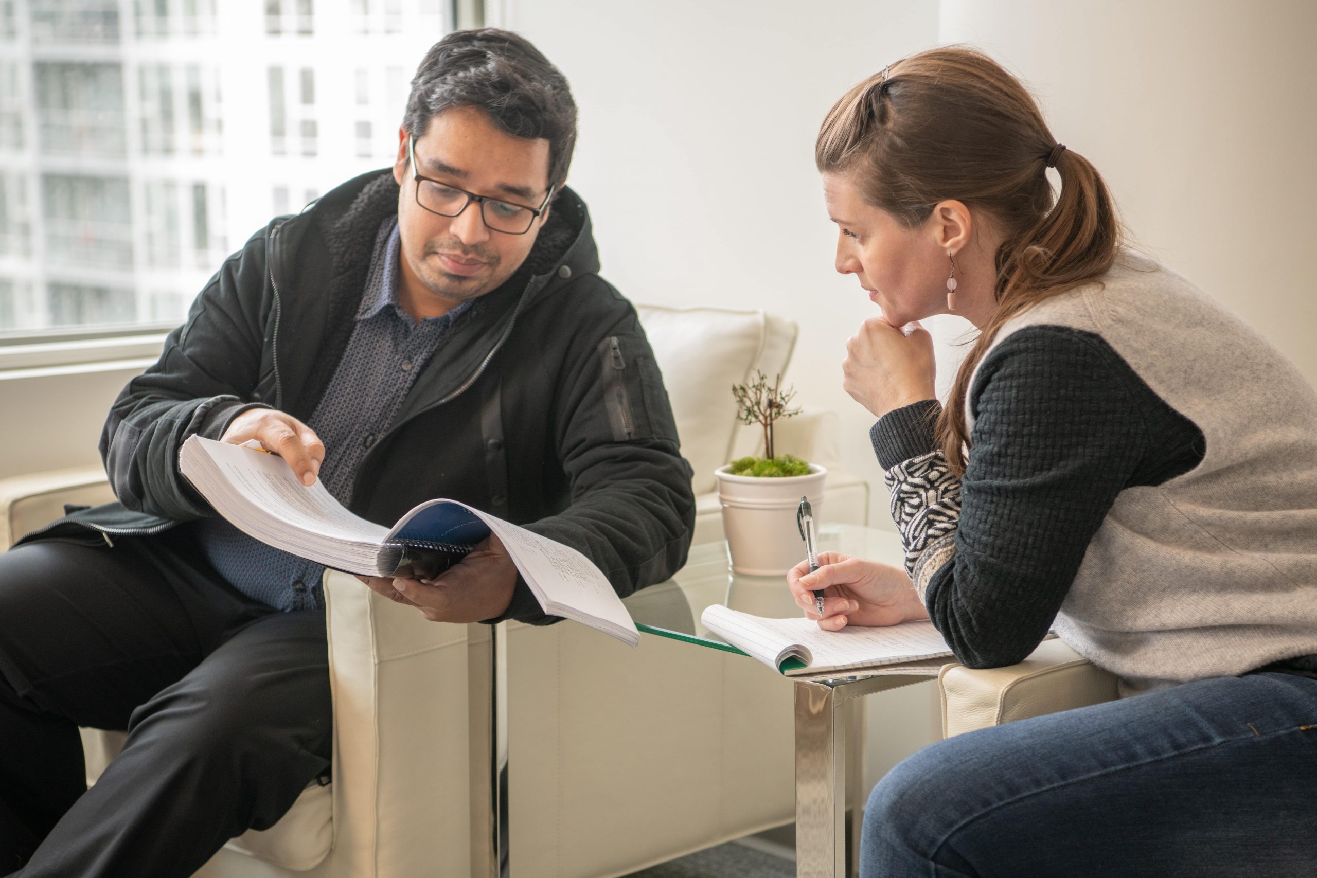 A photo of two people looking at documents.