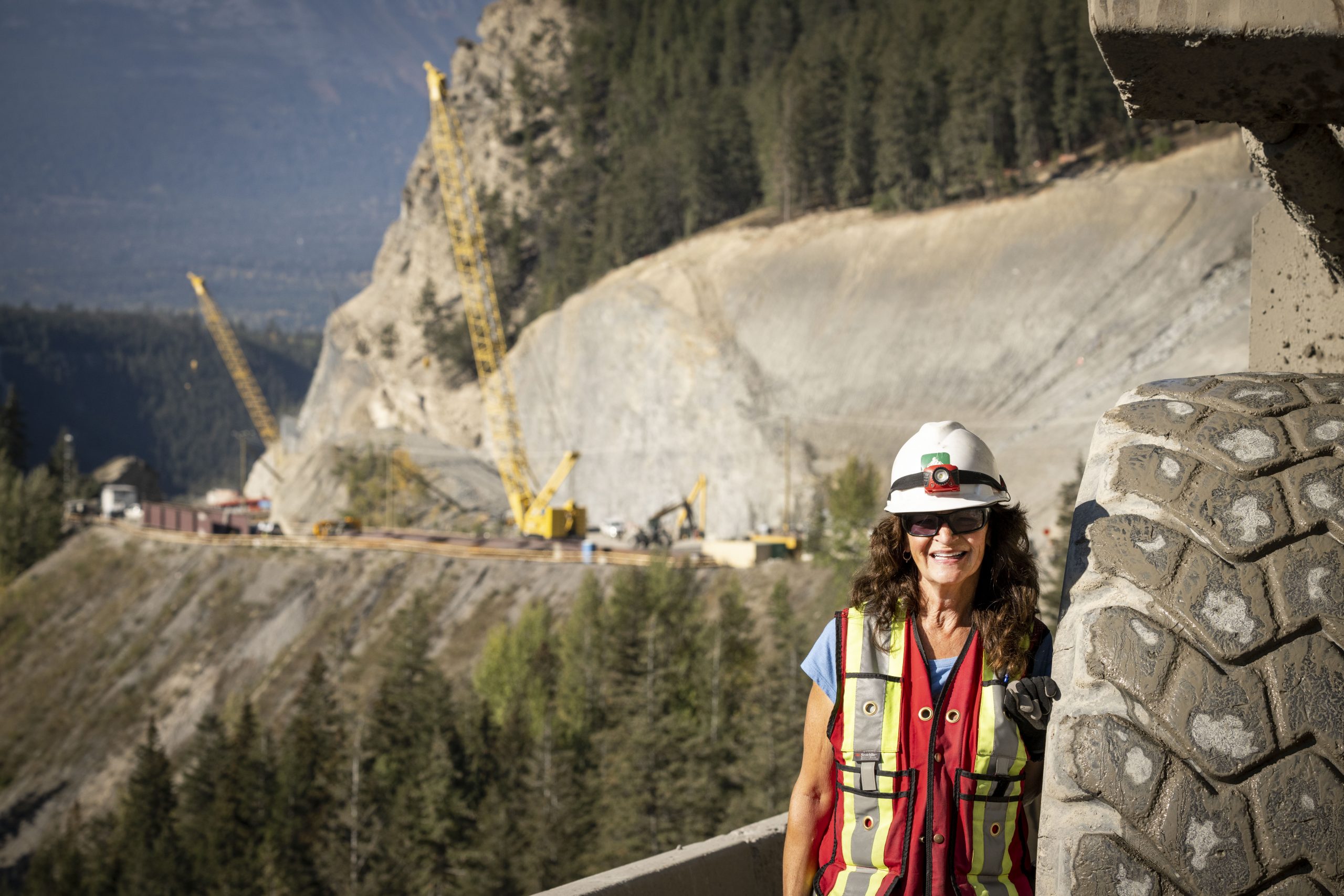 An image of Dawn Purvis standing beside a tire