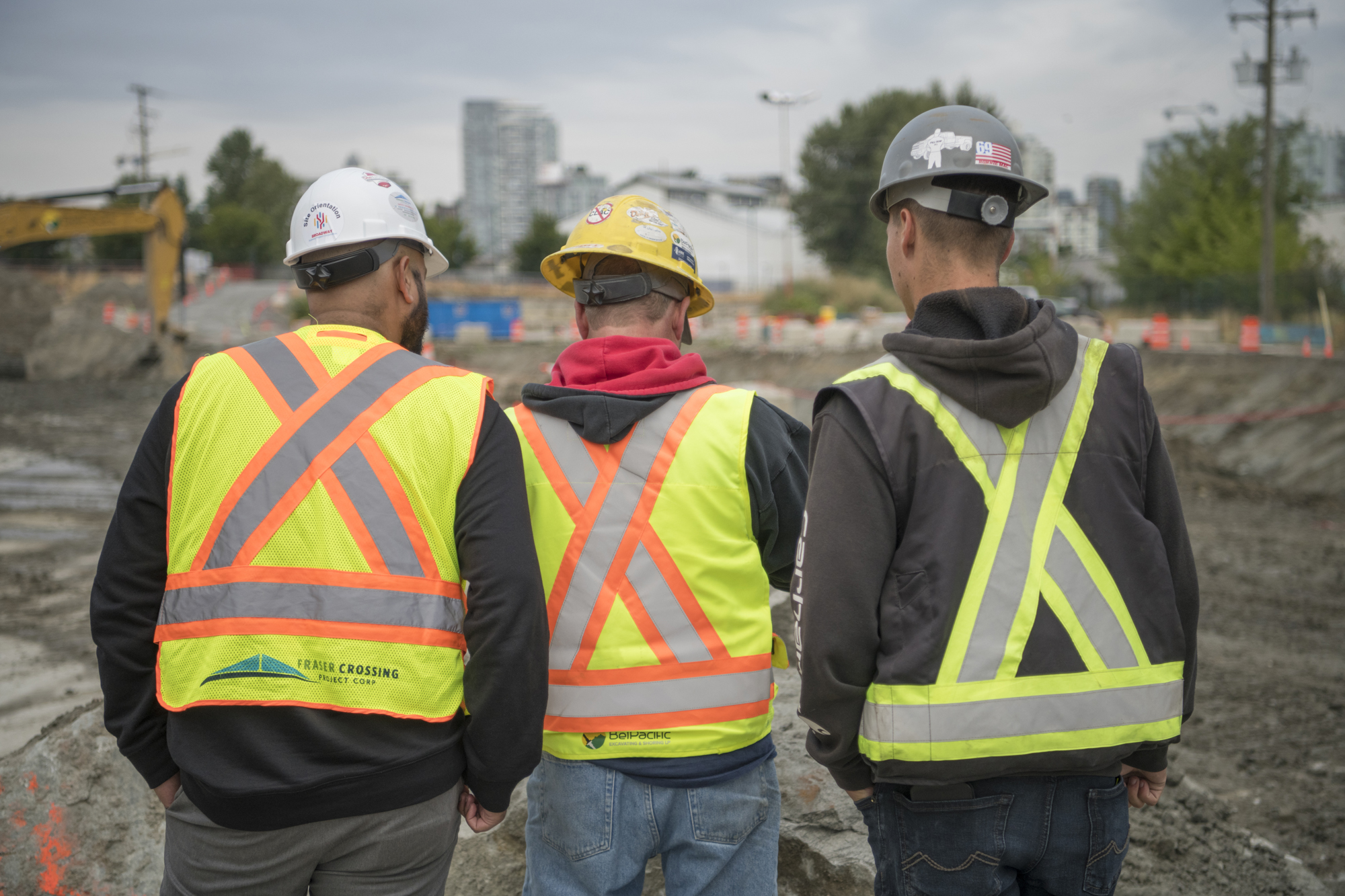An image of three men with backs to the camera
