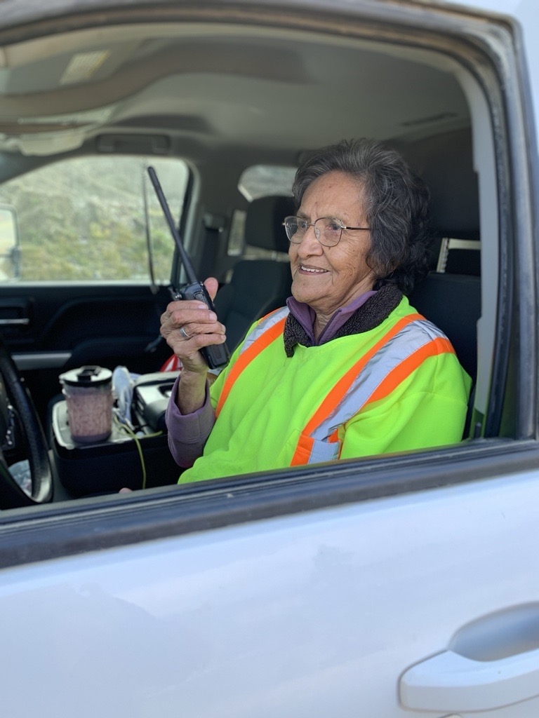 An image of a worker named Doreen inside her car and talking