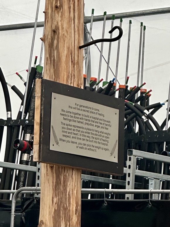 Side view of the Coast Salish cedar post and iron hook, with the plaque in view.